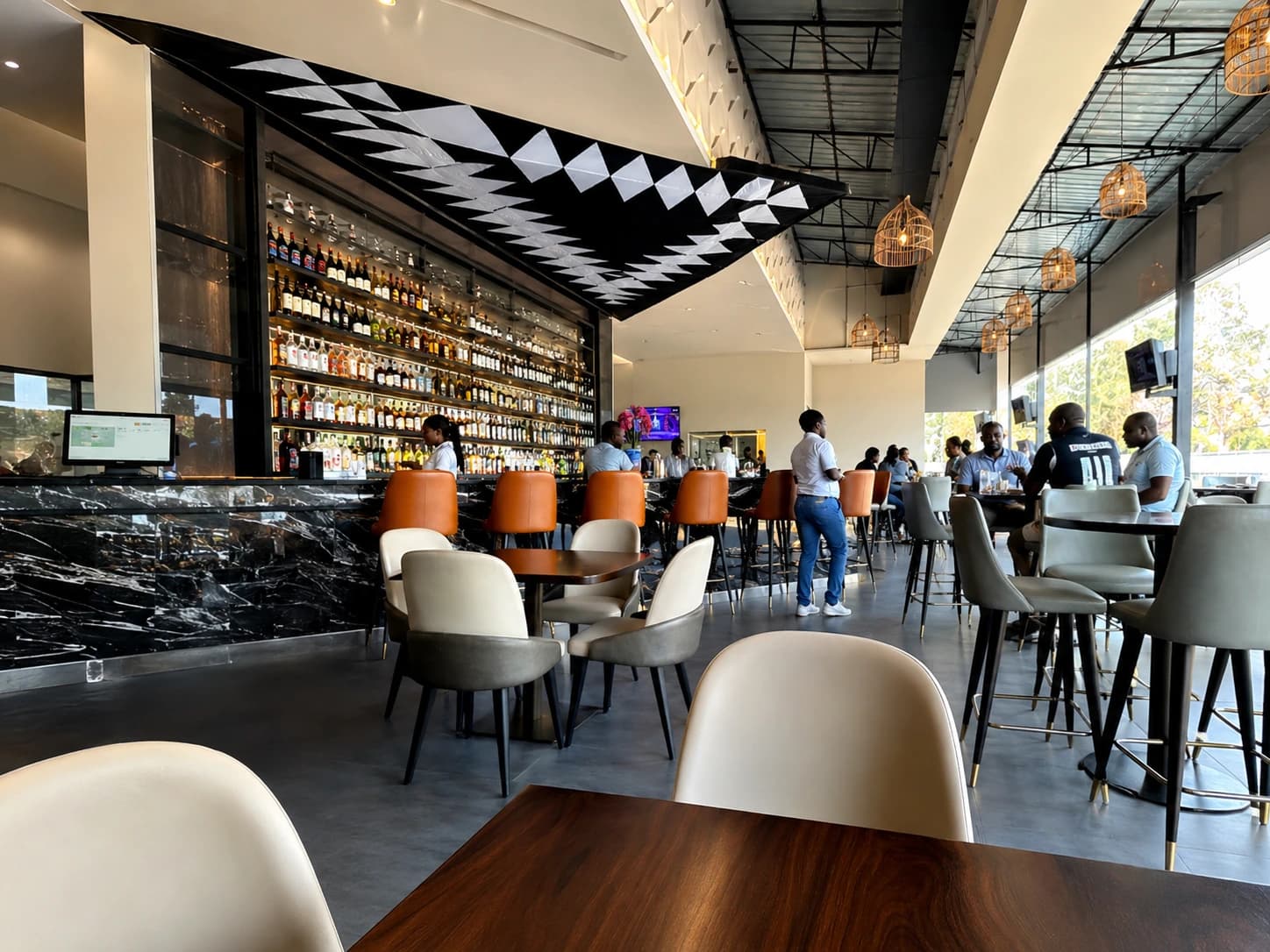 Spacious GreenLeaf Kitchen and Bar lounge with guests and modern seating