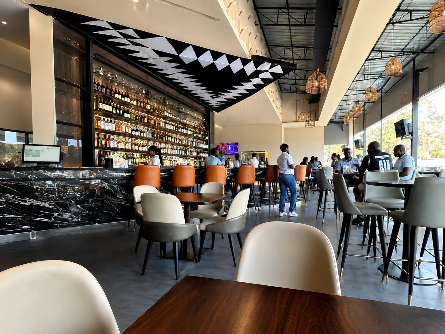 Spacious GreenLeaf Kitchen and Bar lounge with guests and modern seating